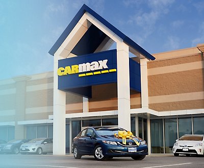 A car is parked in front of a CarMax store.