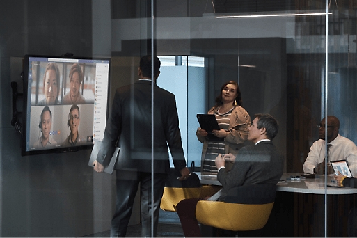 Video call on screen with multiple persons in a meeting room